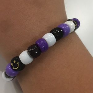 White, black, purple with black smiley faces bracelet.